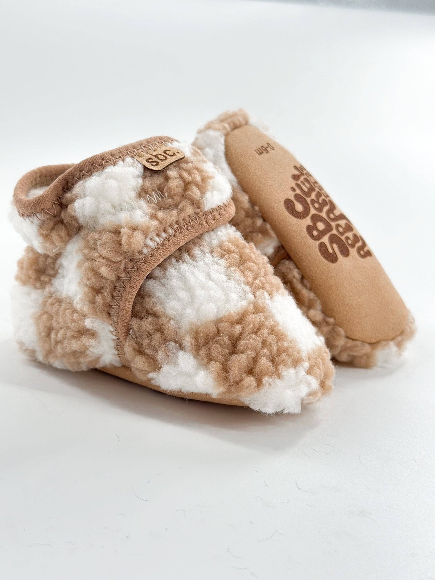 The Newborn Sherpa Bootie — Camel + White Checkered