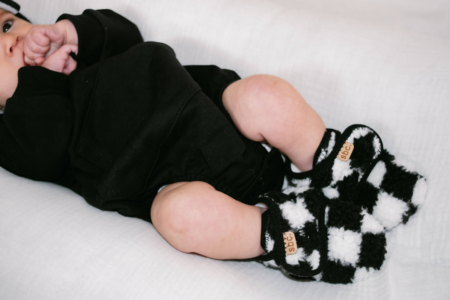 The Newborn Sherpa Bootie — Black + White Checkered