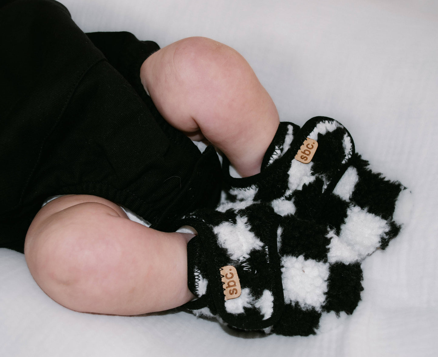 The Newborn Sherpa Bootie — Black + White Checkered